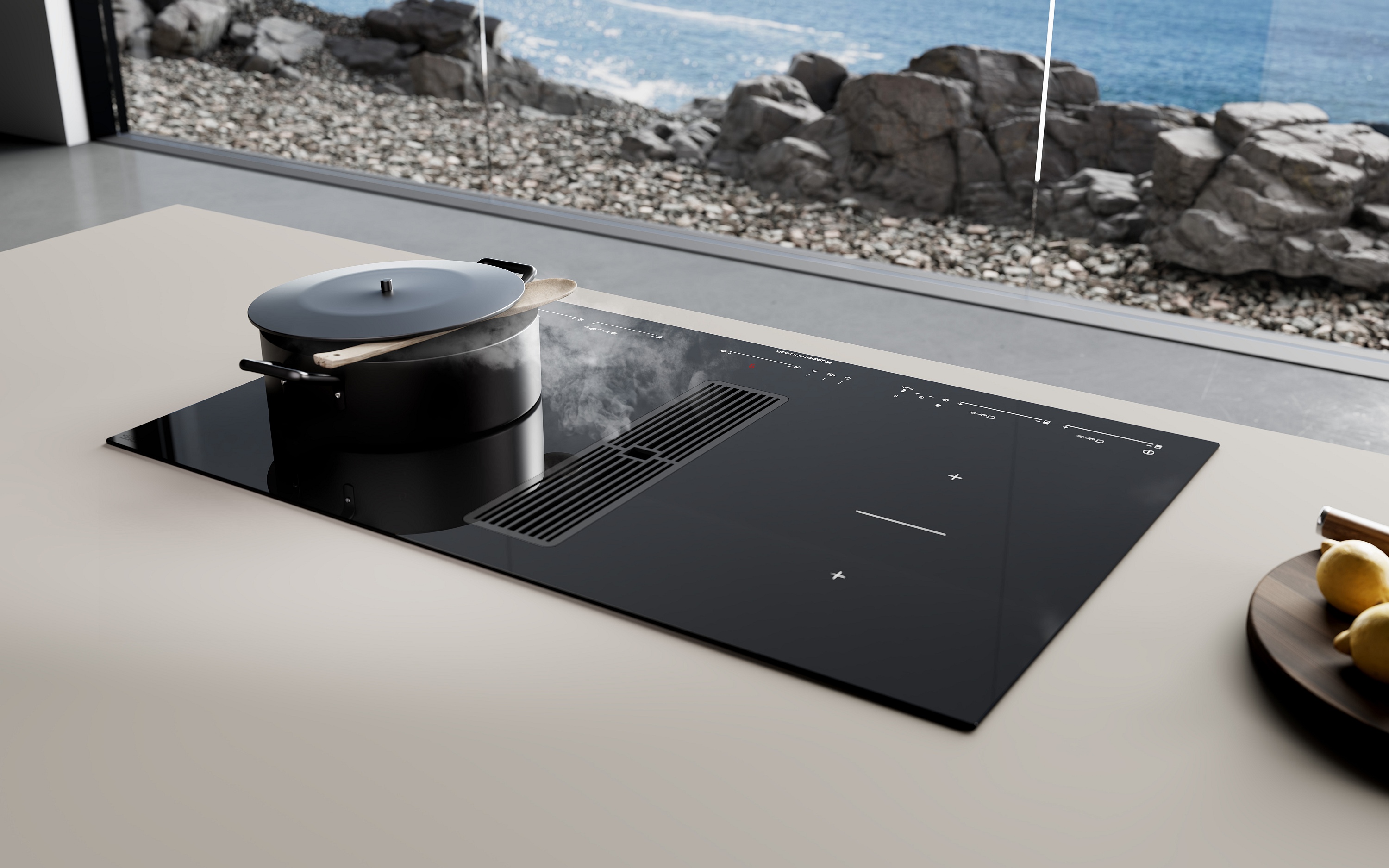 Küppersbusch Induktionskochfeld mit integriertem Kochfeldabzug in weiße Arbeitsplatte eingebaut in Kochinsel Panorama Meeresküste