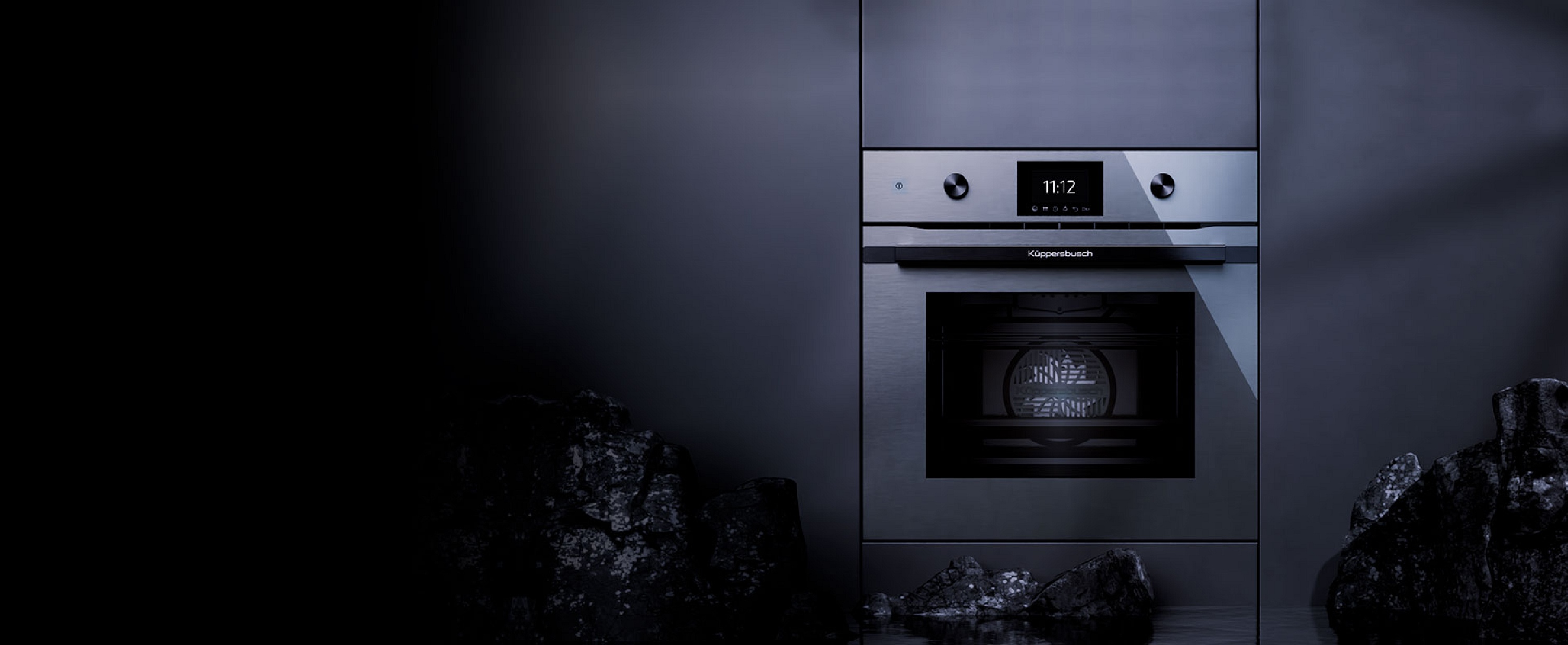 Küppersbusch Graphite-Line Einbaudampfgarer mit sinnbildlichen Kohlebrocken
